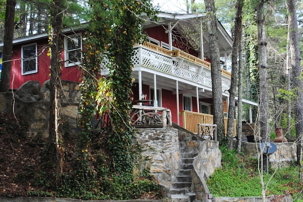 Front of the cabin showing terraced seating areas and porch on second level.