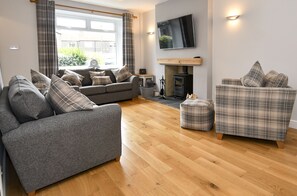 living room with 2 large sofas and a cozy chair
