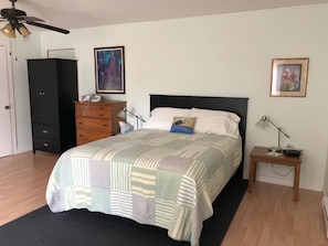 Queen size bed. Reading lamps, dresser and wardrobe.