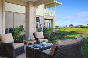 Lanai with distant ocean and golf course views