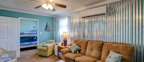 Our living room invites you to unwind just steps from the beach, with access visible right from the house. The cozy downstairs duplex features 2 bedrooms and 1 bath, offering a perfect retreat for your relaxation.