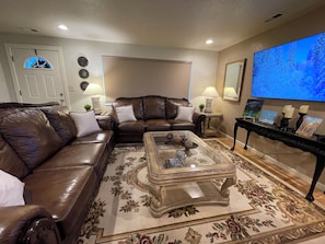 Cozy living room with blackout shades, 2 full sofas & 65 in. smart TV with cable