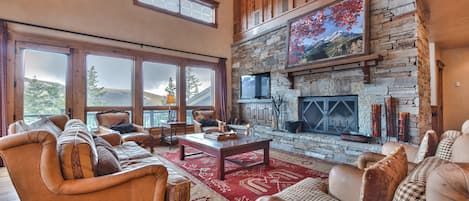 Spacious Living Room with Mountain Furnishings, a Wood Burning Fireplace, 50'' HDTV, Hardwood Flooring, and Mountain Views
