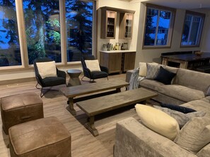 Living room with Bar fridge and dishwasher in the back.  