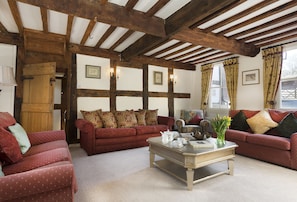 Ground floor: The spacious drawing room with exposed beams and open fire