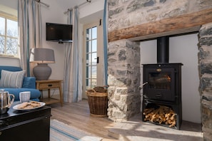 Enjoy a warming fire by the woodburner on a chilly afternoon