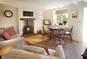 Ground floor: Sitting room with cosy wood burning stove and dining area
