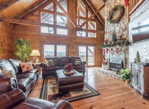 Large Great room with vaulted ceilings, Gable windows , & stone gas fireplace. 