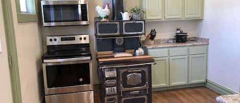 Cute food prep area with a repurposed wood stove. 