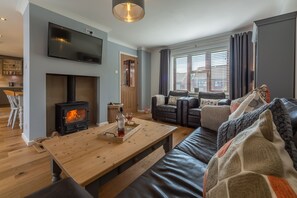 One Lazy Duck, Heacham: Sitting room with wood burning stove