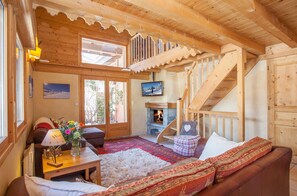 French Mountain Chalet living area. Double hight ceiling, Log Fire.