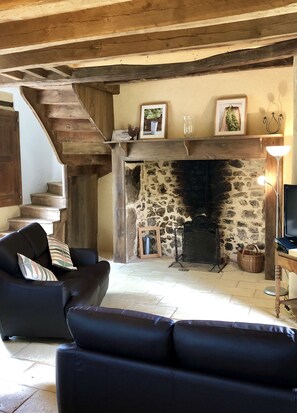 Cosy sitting room with open fireplace