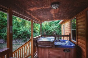 hot tub with a table and chairs on the front patio 