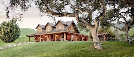 Front view of house from under the oaks.