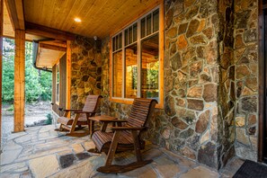 The front porch welcomes you with rocking chairs.