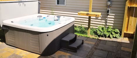 Outdoor private hot tub area. 