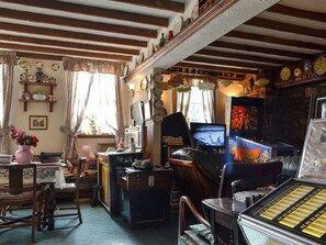 Quirky living room complete with pin ball machine | Chapel Cottage, Pontsticill, Brecon Beacons