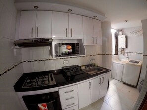 Kitchen with microwave  and  laundry area