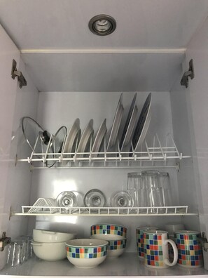 Kitchen equipped with dishes, cups, glasses, wine glasses and others