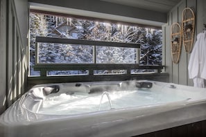 Private hot tub for 4. Bathrobes and extra towels are provided for your comfort.