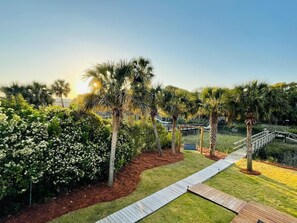 Beautiful sunrise view of the backyard, swing, and dock.