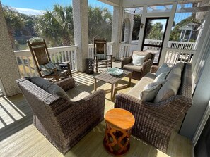 Screened porch overlooking creek and private dock.