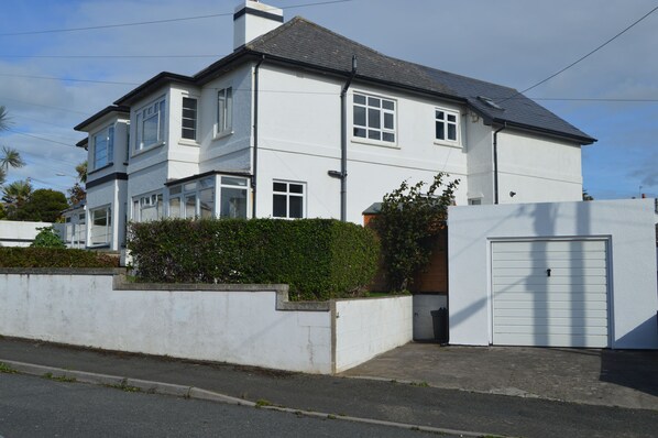 House has large front garden, with shed to store bikes/boards.