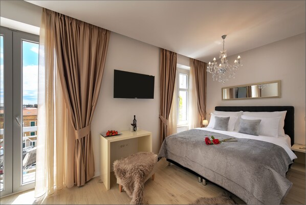 Room with queen size bed and balcony