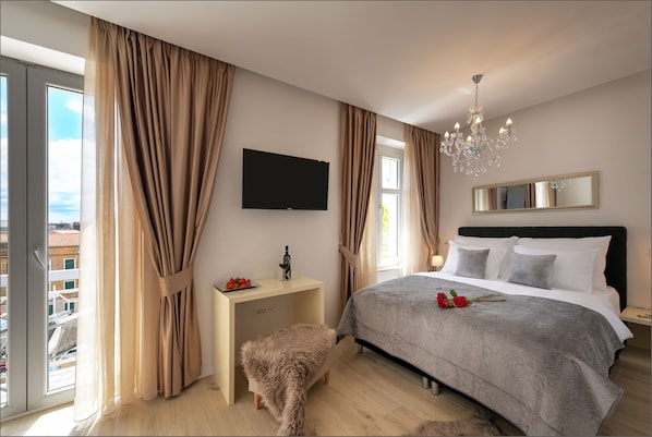 Room with queen size bed and balcony