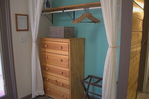 Closet with towel basket and tall dresser