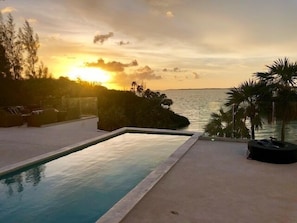 Private heated pool with sweeping ocean and sunset views.