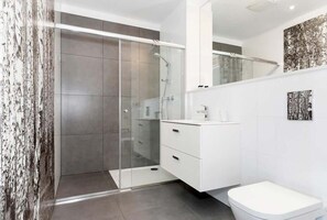 Bathroom with shower and towels. 