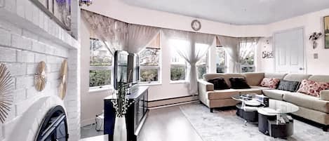 The shiny beautiful elegant open living room space with a gorgeous garden view