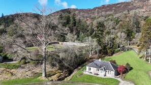 The Bungalow with surrounding grass areas 