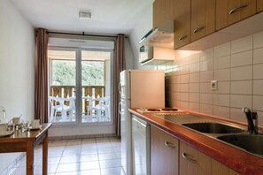 Prepare meals in the small kitchen and enjoy them at the dining table.