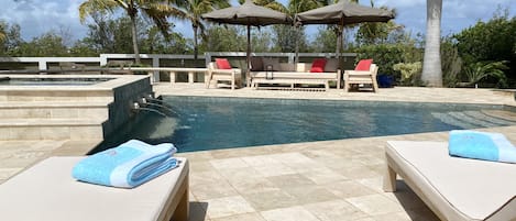 Pooldeck with teak furniture and umbrellas; a peaceful place for relaxing