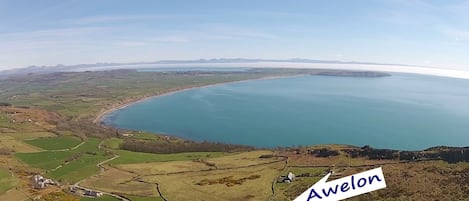 Porth Neigwl Bay in the foreground with Cardigan Bay and Snowdonia Mountains 