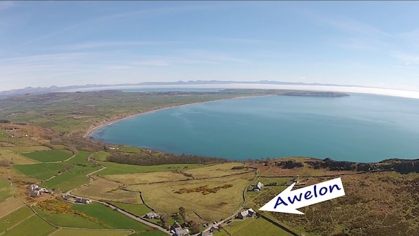 Porth Neigwl Bay in the foreground with Cardigan Bay and Snowdonia Mountains