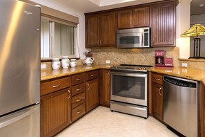 Fully stocked Kitchen with granite counter tops and stainless appliances