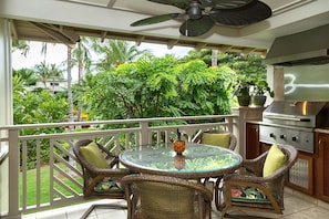 Lanai with table, chairs and built in bar-b-que with garden/pool view