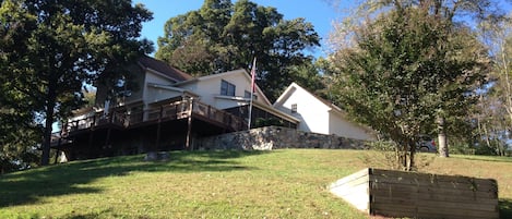 View of home coming up driveway. Home sits of hill with majestic views of nature