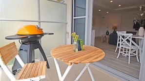 Relax and unwind on your private balcony with BBQ and outdoor setting.