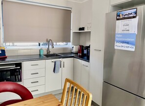 Kitchenette includes full fridge, microwave, air fryer, induction cooktop etc