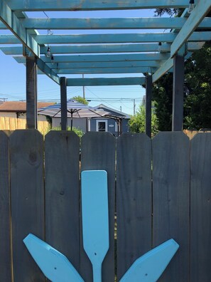 Custom built pergola and gate greet you at the entrance to your outside oasis