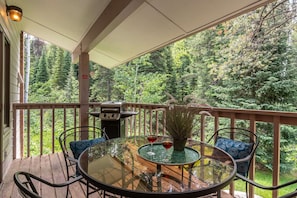 Take in the forest off your private deck with seating for four & gas grill
