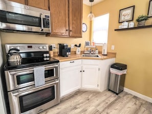 Kitchen has double oven and glass cooktop