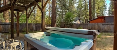 Gas BBQ, hot tub and seating in the backyard