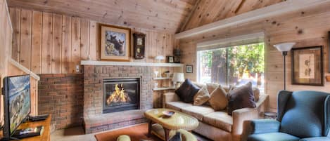 Cozy mountain living room with gas fireplace, flat screen TV