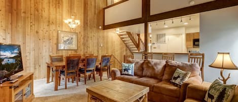 Living room w/ DVD player, flat screen TV, wood burning fireplace, board games