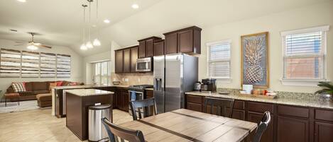 Open concept dining, eat-in kitchen, and spacious living room.